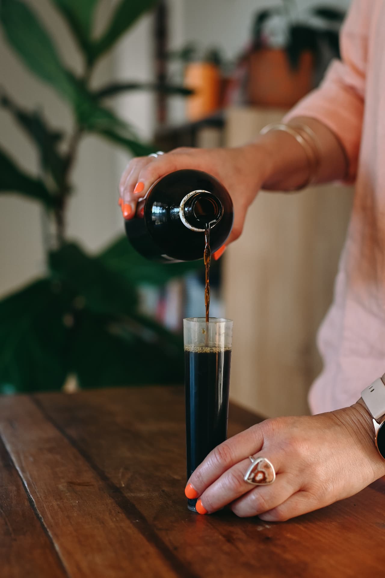 Anna preparing a liquid herbal extract for a patient